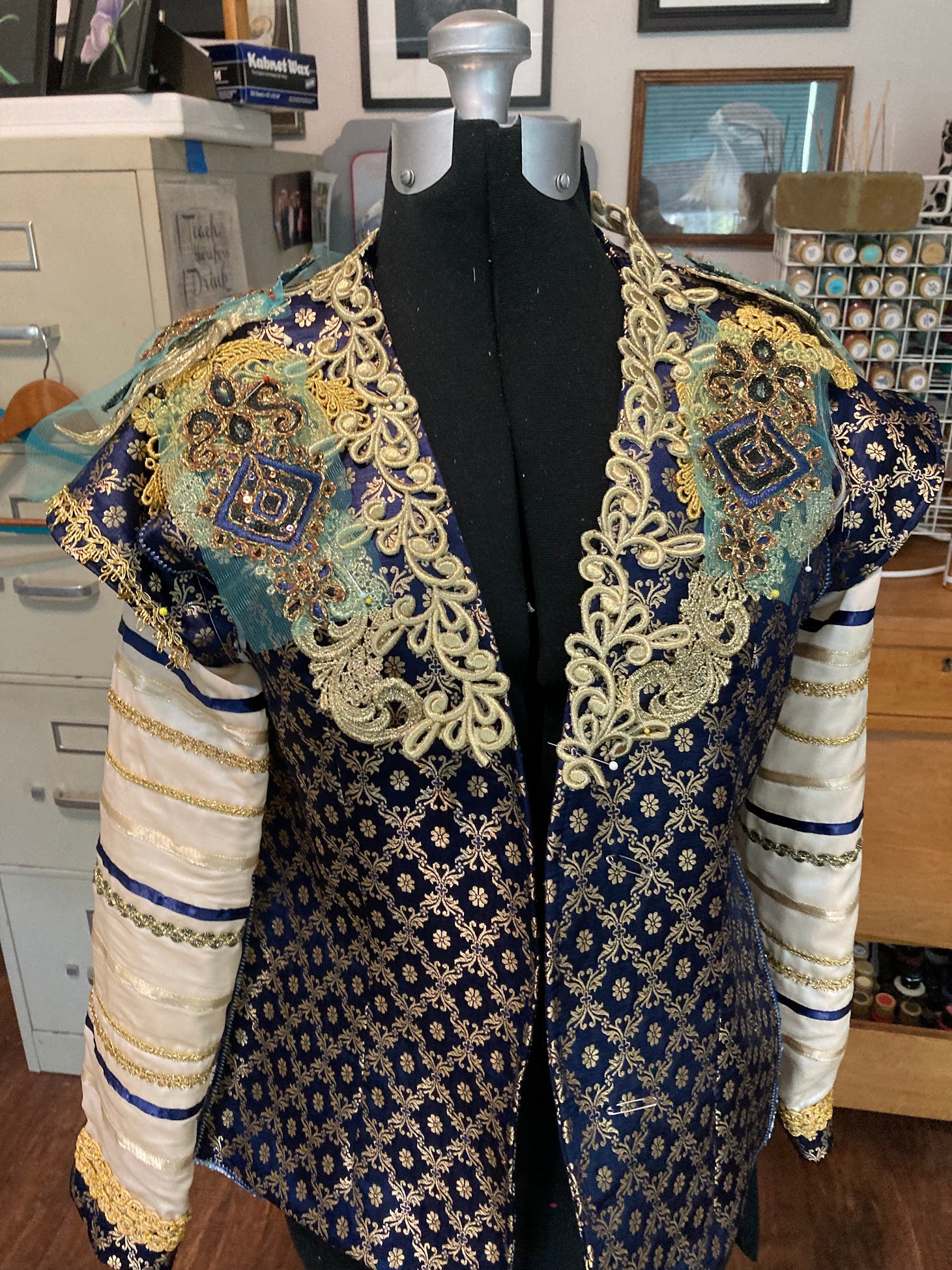 Dark blue and gold brocade men's ballet jacket with attached sleeves.