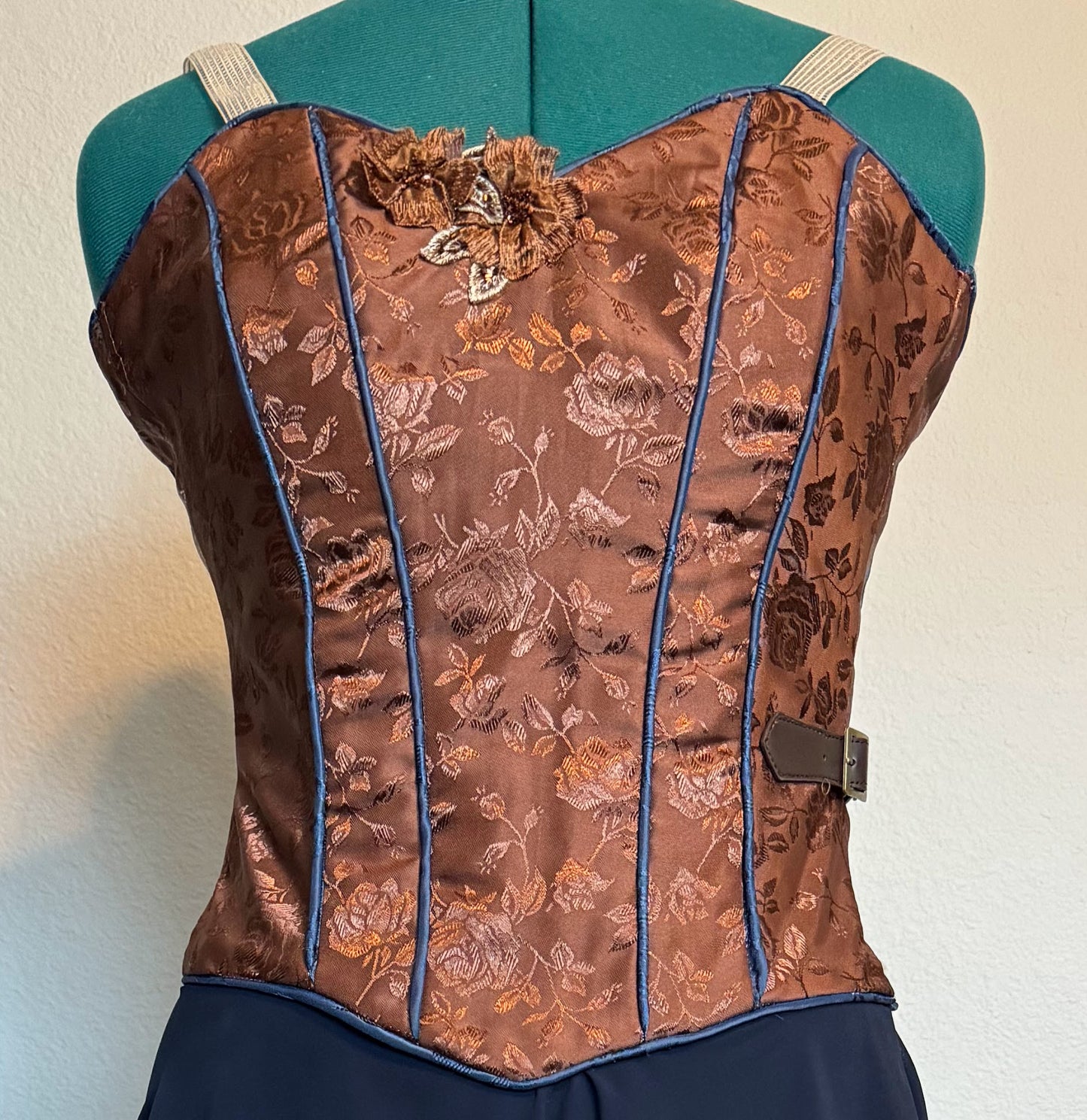 Dark brown brocade ballet bodice with blue trim.